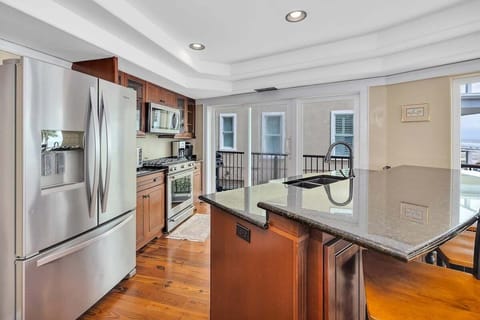 First-floor kitchen with stainless steel appliances and island