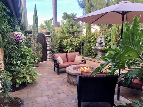 Tranquil private tropical courtyard with fire pit.