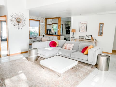 Bright sunny living room, marble floors, comfy sofa