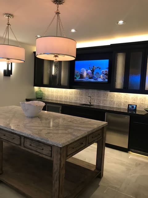 Oasis Suite Bar Area with 50” screen TV which mirrors an 85” screen surround