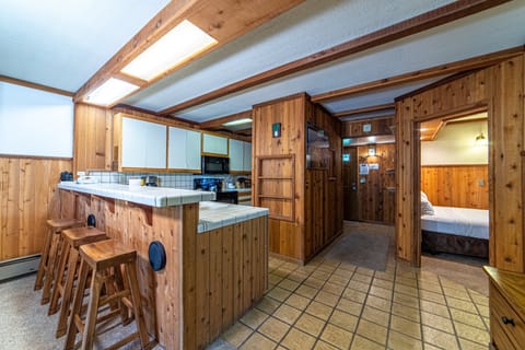 Open Kitchen with bar seating, entry hall and second bedroom entrance.