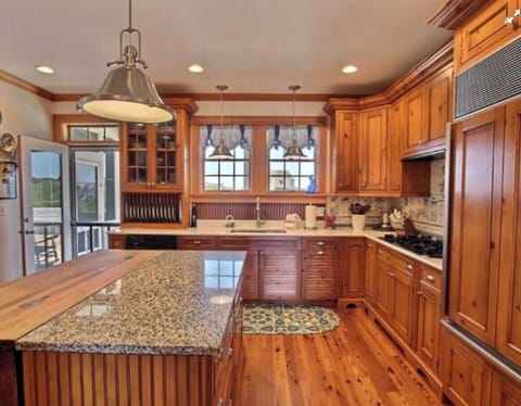 Access to huge south deck & covered grilling area