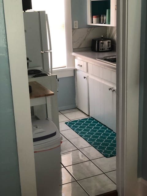 View into full kitchen. New 4 slice toaster and newer, full refrig. 