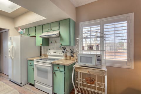 Galley kitchen. Painted cabinets with talevera knobs. Hand painted tiles.