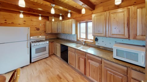The kitchen has plenty of counter space and everything you need to cook meals. 