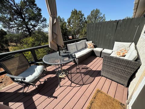 Private patio with lush greenery and city view.