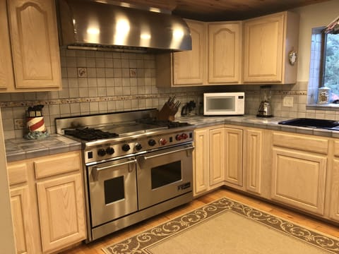 Main House: Wolf 48" range with double ovens and grill 
