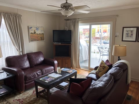 Living room with 40” Chromecast  TV and access to deck