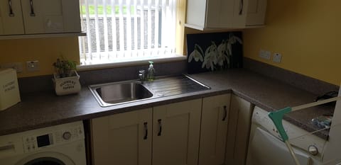 Utility room with washing and drying machines.. also iron and ironing board.