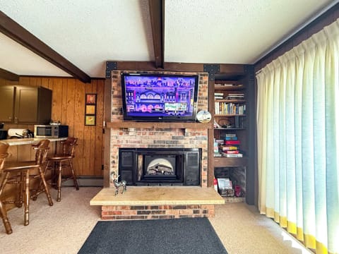 Cozy nights at Cabin Fevers with Roku TV and glow of electric fireplace.