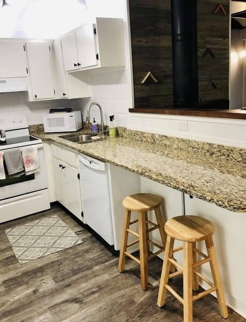 Kitchen with bar top seating.