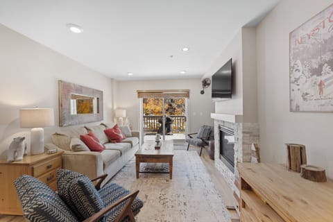 Your bright living space invites relaxation with cozy seating around a crackling fireplace and mountain views from your private balcony.