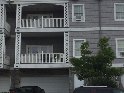 Exterior photo of our third floor condo unit which includes 2 outdoor chairs.