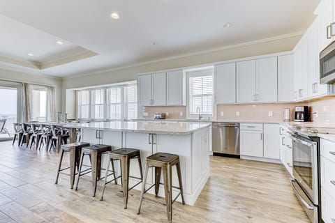 Fully Equipped Kitchen with Stainless Steel Appliances and Breakfast Bar Seating for Four