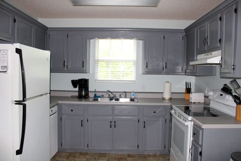 A spacious kitchen awaits you with basic pantry items along cooking essentials.