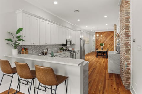 Bar stool seating in living room overlooking the kitchen