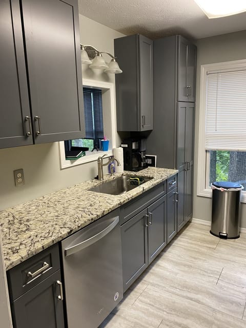 Full kitchen with electric stove/oven, microwave, dishwasher, w/ pots and pans