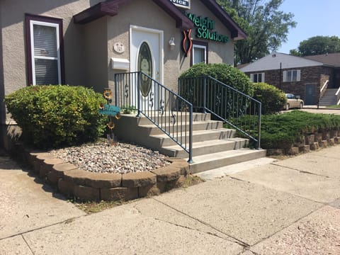 Front of house has business signage on the exterior.