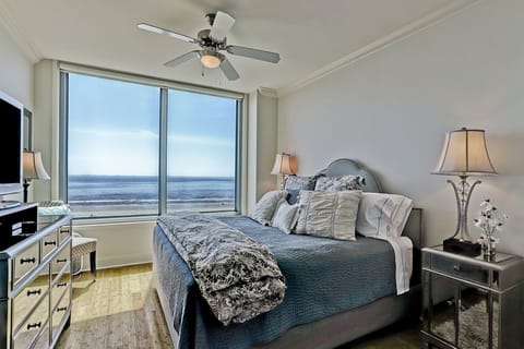 Master suite with king bed, flat screen TV and walk-in closet.