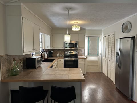 2 barstools at kitchen counter for additional seating. 
