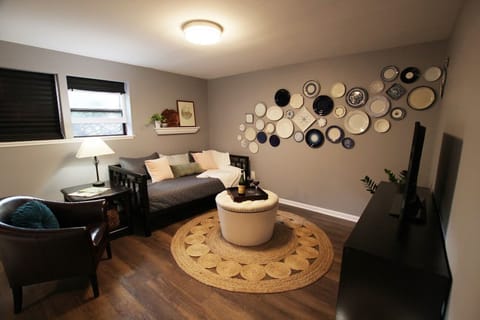 Day bed in living room area with plate wall for accent. 