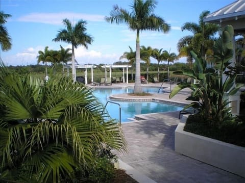 Community pool, hot tub,  and landscaping is picturesque.