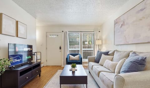 Open living room with sleeper sofa, smart tv, and dining