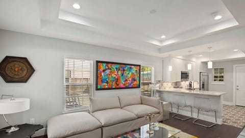 Living room open to the kitchen with large smart tv