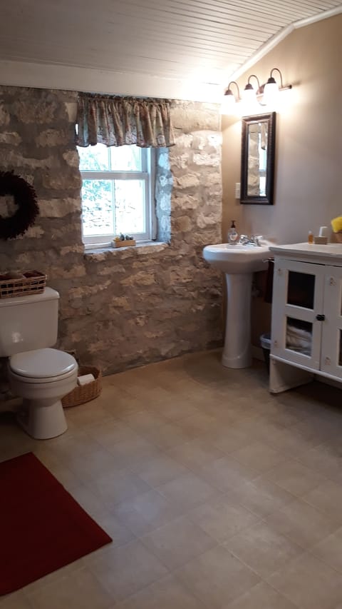 Bathroom with two pedestal sinks and tiled shower