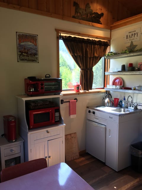 Kitchenette with stove top, microwave, fridge, toaster oven, coffee maker 