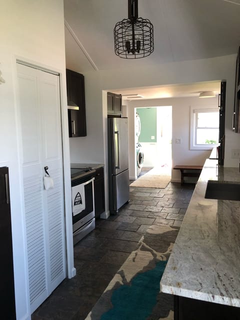 Kitchen and view of washer dryer in entryway