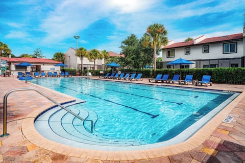 Swim morning laps in a bright, spacious resort pool.