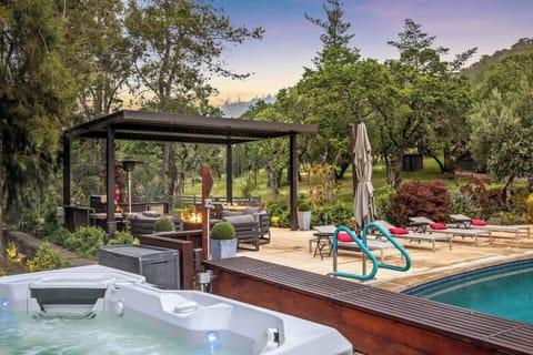 This is the full picture: saltwater pool, 6-person hot tub, outdoor kitchen, fire table, and pergola dining — all yours for the week. This is what Sonoma wine country evenings were made for.