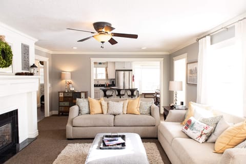 A bright and beautiful family room greets our guests with an open floor plan leading into the dining room and kitchen. French doors, recently added to access the new deck, hot tub and fire table.