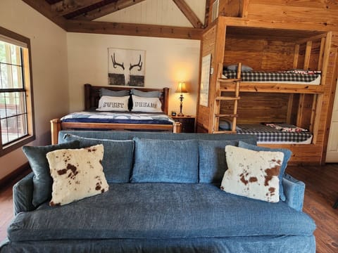 Open floor plan with king bed and bunk beds