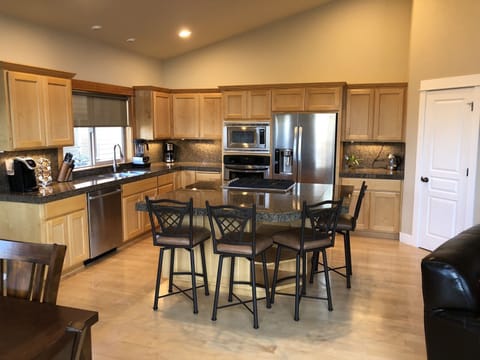 Kitchen has all new, high-end appliances, a huge island, tons of cooking tools.