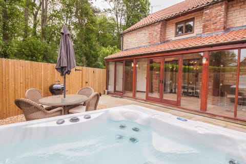 Enclosed garden with outside dining furniture, bbq and hot tub