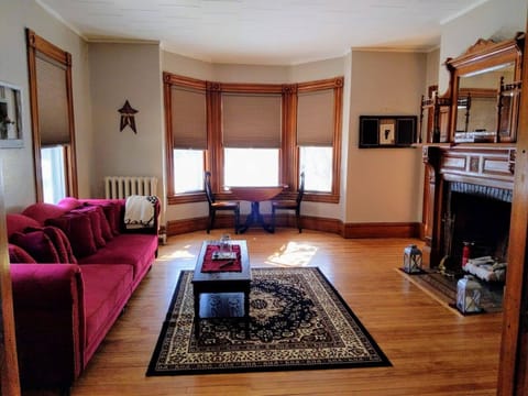 Spacious living room, with nook, and original 1880's fireplace.
