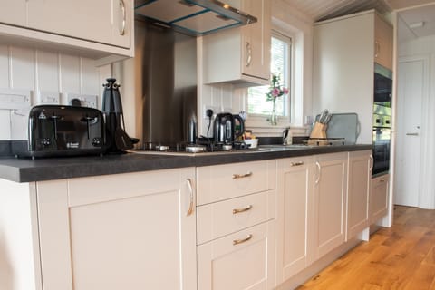 Fully fitted kitchen, gas hobs, microwave, oven and American style fridge/freezer