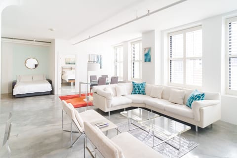 Open living and dining space with a down-filled sectional and a separate sofabed