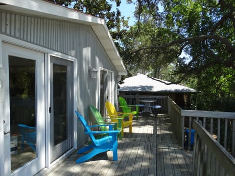 Shaded Deck with Adirondack Chairs and a outdoor dinning table.