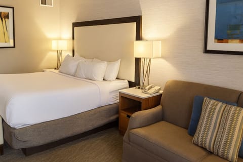 Drift off fast in crisp linens and warm bedside glow.