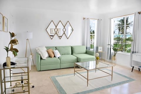 Lounge on the chic sofa while palms sway outside.