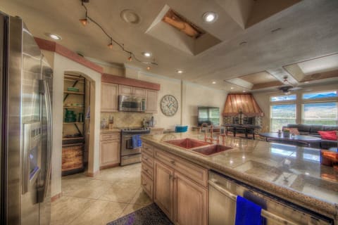 Gorgeous fully stocked and well equipped kitchen with the open concept design to not miss the conversation and views while cooking your delicious meal.