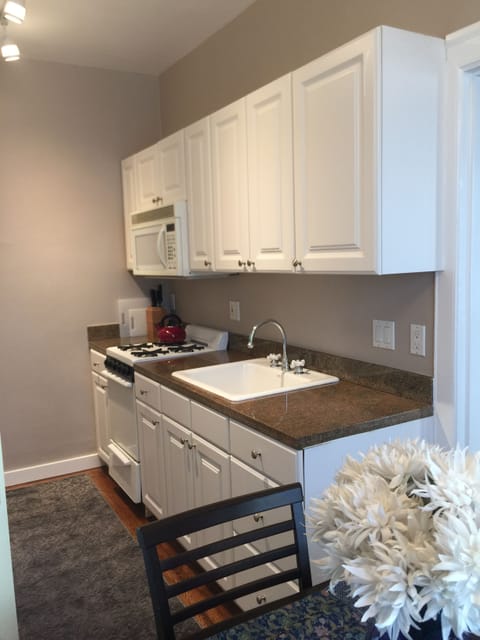 Kitchen right side, granite countertops, 20” gas range/ oven, and microwave 