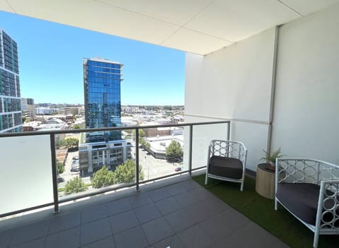 Private balcony with stunning city views and comfortable seating.