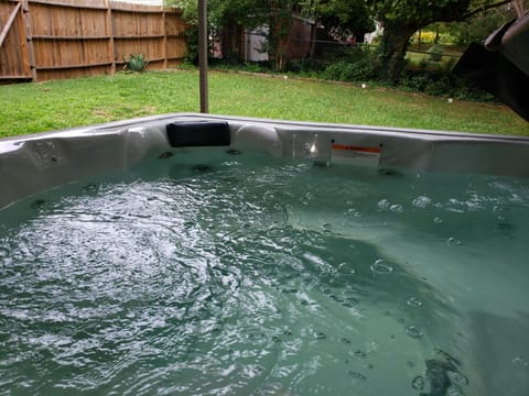 Hot Tub Overlooks Fenced Yard
