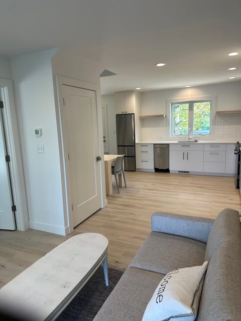 View of kitchen from living area. Mini fridge & dishwasher. 