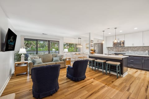 Living room with flat screen tv and a sofa bed.