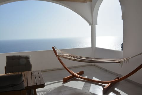 The balcony offers a seating area and a hammock. There is a retractable sunoof